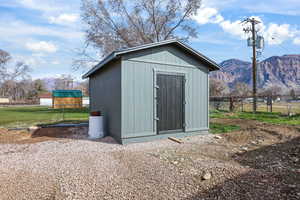 View of shed featuring a fenced backyard and a mountain view