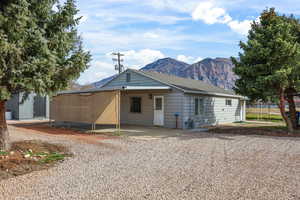 Single story home with a mountain view and a patio