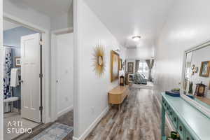 Hallway with light wood finished floors and baseboards