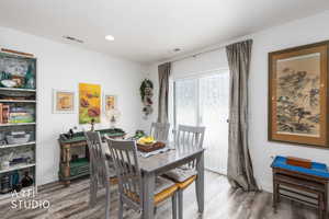 Dining area featuring wood finished floors and recessed lighting