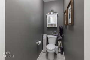 Bathroom with toilet and light tile patterned floors
