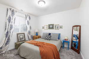 Carpeted bedroom with baseboards