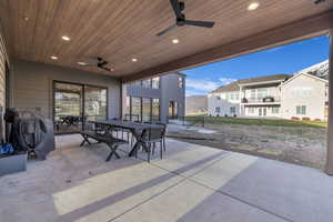 View of patio featuring outdoor dining space, ceiling fan, a mountain view, and area for grilling