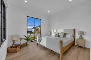 Bedroom featuring light wood-type flooring, recessed lighting, and access to outside
