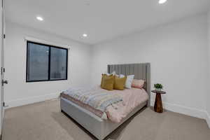 Bedroom with light carpet and recessed lighting