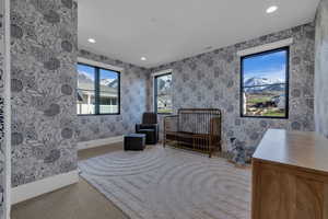 Sitting room featuring recessed lighting, light carpet, and wallpapered walls