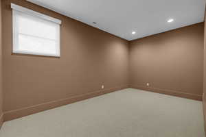 Carpeted spare room featuring recessed lighting and baseboards