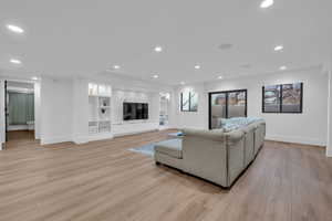 Living area featuring light wood-type flooring and recessed lighting