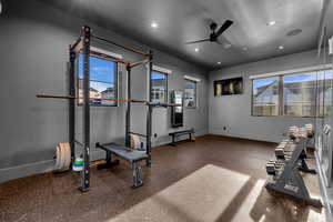 Workout area with a ceiling fan and recessed lighting