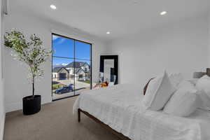 Carpeted bedroom with access to outside and recessed lighting