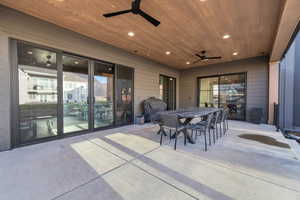 View of patio / terrace with a ceiling fan, outdoor dining space, and a grill