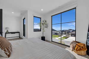 Bedroom with light carpet, access to exterior, and recessed lighting