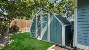 View of shed with a fenced backyard