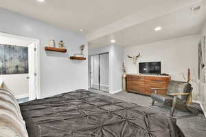 Bedroom with carpet flooring, recessed lighting, and a closet