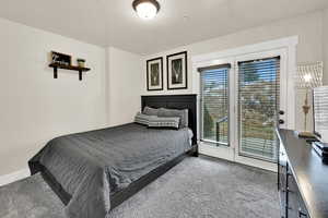 Bedroom with light colored carpet and access to exterior patio
