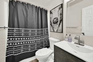 Full bathroom featuring vanity and a shower with shower curtain