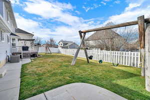 Fenced backyard featuring a deck and a residential view