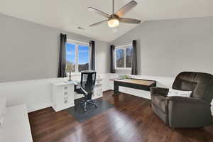 Office space featuring dark wood finished floors, lofted ceiling, and ceiling fan