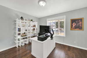 Office space with dark wood finished floors and baseboards