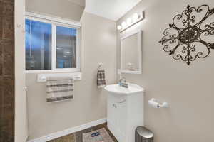 Bathroom featuring vanity and baseboards