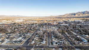 Aerial overview of property's location with mountains and nearby suburban area