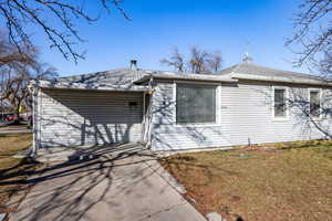 View of front of house featuring roof with shingles and a front lawn
