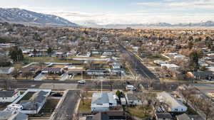 Aerial view of property's location featuring a mountain backdrop and nearby suburban area