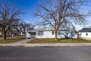 View of front of house with a front lawn and driveway
