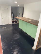 Bar featuring butcher block countertops and recessed lighting