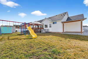 View of playground with a patio and a fenced backyard