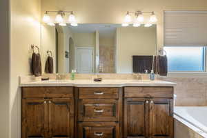 Bathroom with double vanity and a bath