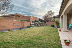 Fenced backyard featuring a patio