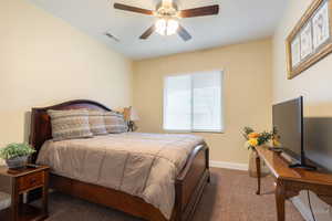 Bedroom featuring dark carpet and ceiling fan