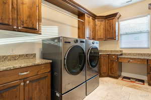 Laundry room with cabinet space and washer and dryer