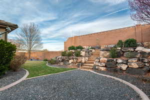 Fenced backyard featuring stairs