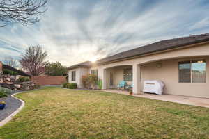 Back of house with stucco siding and a patio area