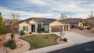 View of front of property featuring a garage, stucco siding, driveway, a tile roof, and stone siding