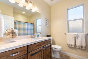 Bathroom with vanity, curtained shower, and light tile patterned floors