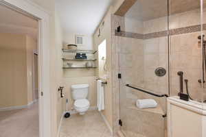 Full bathroom with a stall shower and light tile patterned flooring