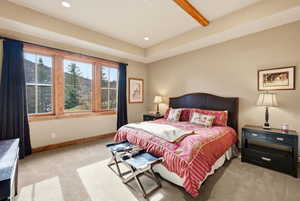 Bedroom with light carpet, recessed lighting, beam ceiling, and a mountain view