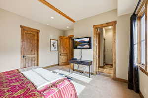 Bedroom featuring light colored carpet and baseboards