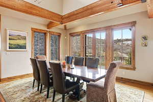 Dining area featuring wood finished floors and beamed ceiling