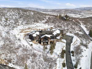 Snowy aerial view featuring a mountain view