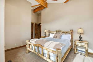 Bedroom featuring a ceiling fan, carpet floors, and lofted ceiling