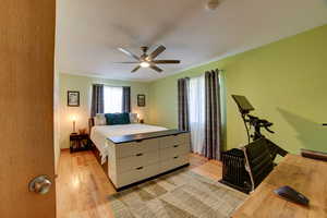 Bedroom featuring light wood-style floors and a ceiling fan