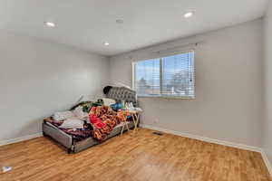 Bedroom featuring light wood-type flooring and recessed lighting