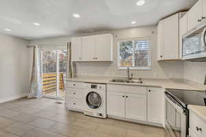 Laundry area featuring washer / dryer and recessed lighting