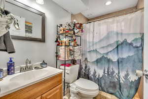 Bathroom with vanity, curtained shower, and light tile patterned flooring