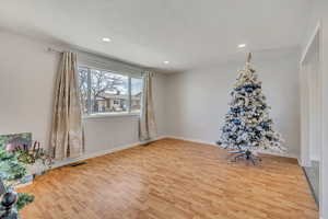 Unfurnished room with light wood finished floors and recessed lighting