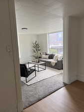 Living room featuring light wood-style floors and baseboards